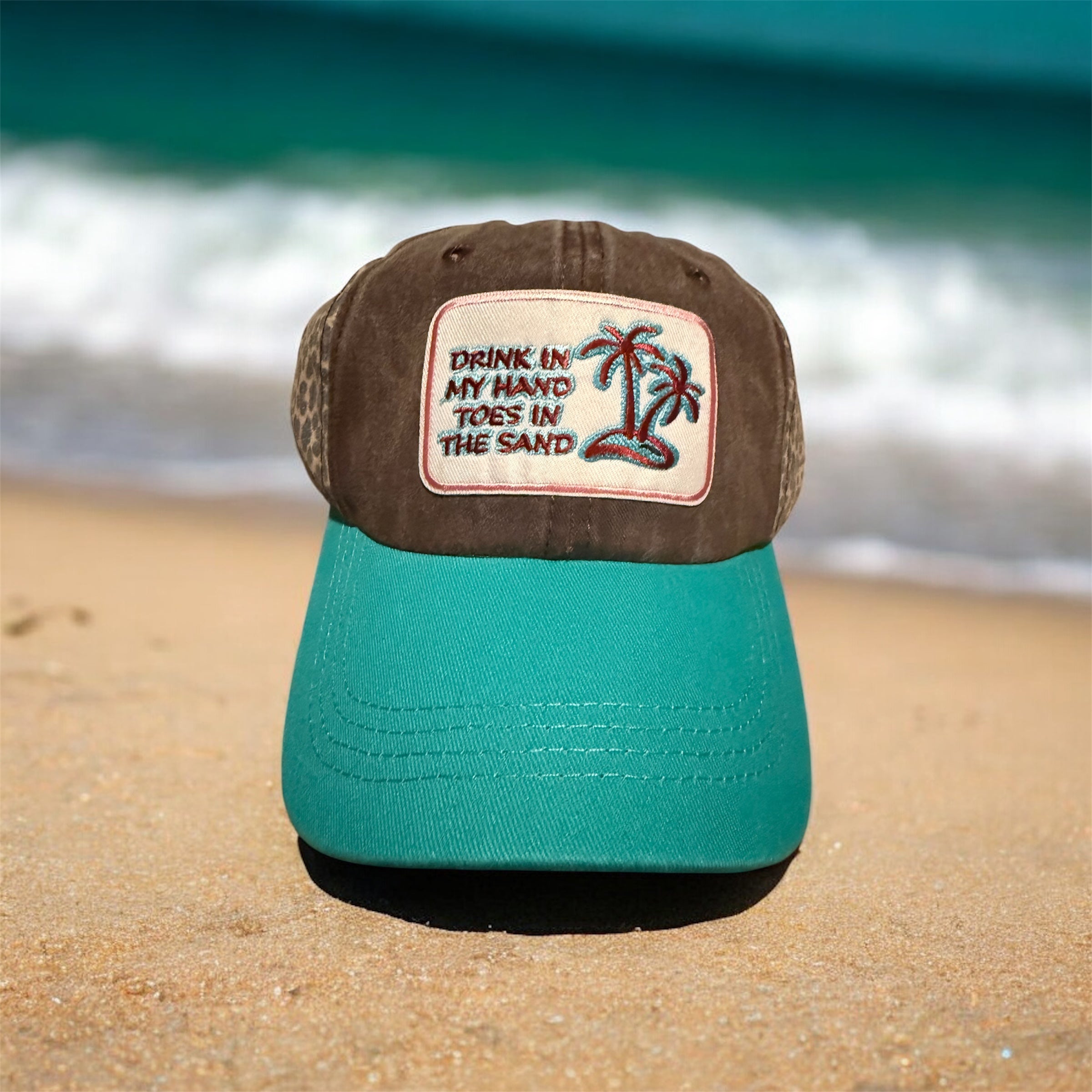 Drink in hand/toes in sand